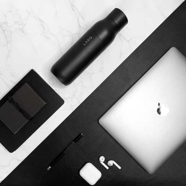 Photo of LARQ Bottle - Obsidian Black on table with laptop