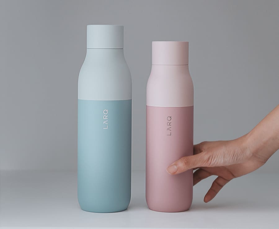 2 Larq bottles with pink and light green sleeve
