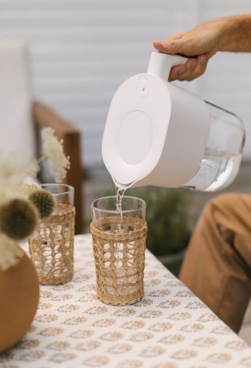 LARQ Pitcher PureVis™ Pure White sipping water in the glass