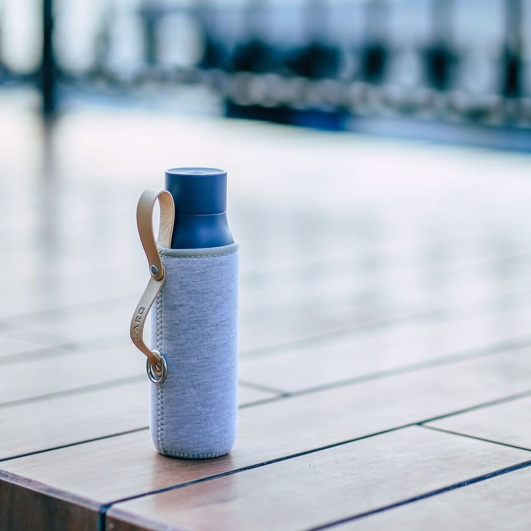 Photo of LARQ Bottle PureVis™ - Monaco Blue in Travel Sleeve on wooden floor