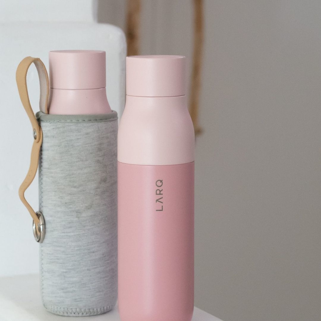 Photo of LARQ Bottle PureVis™ - Himalayan Pink in Travel Sleeve on staircase